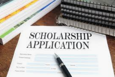 A scholarship application and pen